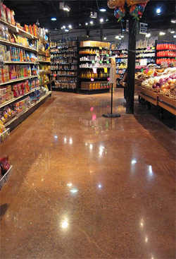 Custom Concrete Solutions LLC transformed this retail space with stained concrete that is reflective enough to see the lights of the ceiling.