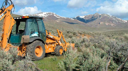 Lander County, Nevada: Desert terrain and neutral, almost bland, colors provide contrast to and act as a great canvas for punchy colors, such as the orange of this backhoe, or, better perhaps, the rich blue of the sky. 