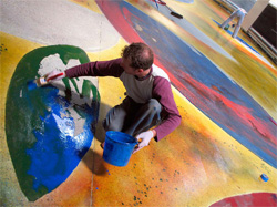 Concretist artist associate Martin Webb applies thinned water-based acrylic, intensely saturated with Deso Dye Concentrates and Aquacolors from Colormaker. The layout and material application was done by hand and by eye, with no mechanical aids. That's one really big watercolor!