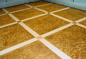 A skip-troweled microtopping with Miracote’s architectural water-based stain, Mirastain II. There are two colors used on this floor. One is a liquid pigment (ColorPax-LIP Tiger Gold) and the other is a dry metallic pigment (Pale Gold).