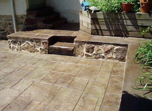 Color hardened concrete steps in dark brown. Patio stamped tile pattern colored tan.